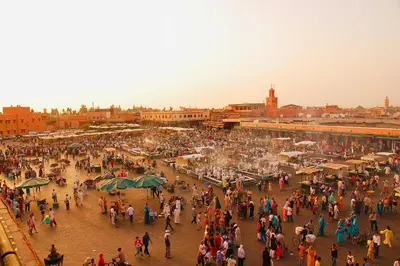 a large crowd of people walking around a city at Nomad's Cosy Apartment Gueliz Center in Marrakech