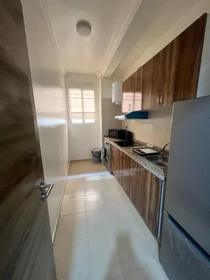 a kitchen with a refrigerator and a counter top at Appartement Marrakech aéroport Menara airport Gueliz in Marrakech