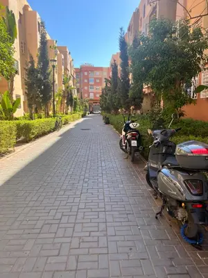 a couple of motorcycles parked on the side of a street at Appartement Marrakech aéroport Menara airport Gueliz in Marrakech