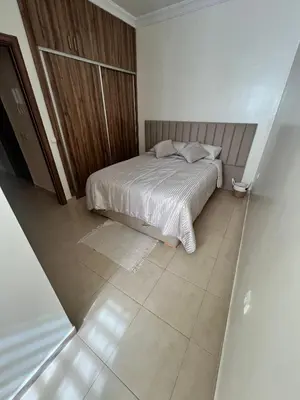 a small bedroom with a bed and a tiled floor at Appartement Marrakech aéroport Menara airport Gueliz in Marrakech