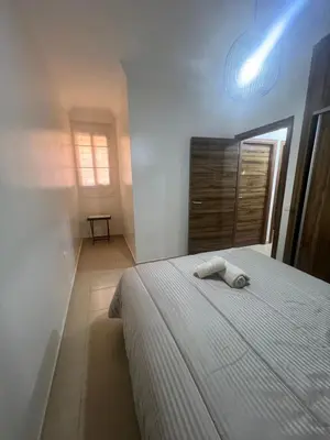 a bedroom with a bed with two towels on it at Appartement Marrakech aéroport Menara airport Gueliz in Marrakech
