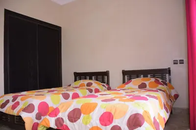 a bedroom with a bed with a colorful comforter at Capstay Riad Villa in secure residence in Marrakech