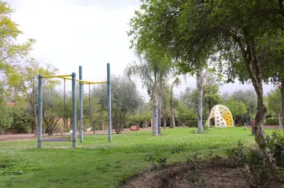 a park with a playground with a yellow slide at Capstay Riad Villa in secure residence in Marrakech