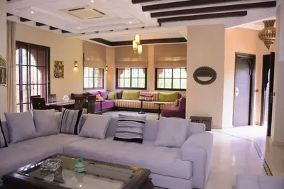 a large living room with a couch and a table at Capstay Riad Villa in secure residence in Marrakech