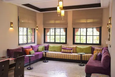 a living room with a purple couch and windows at Capstay Riad Villa in secure residence in Marrakech