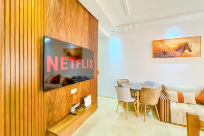 a living room with a television and a table at 17 - Top Location, NEUF, piscine & Comfort in Marrakech