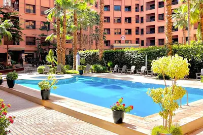 a swimming pool in the middle of a building at 17 - Top Location, NEUF, piscine & Comfort in Marrakech