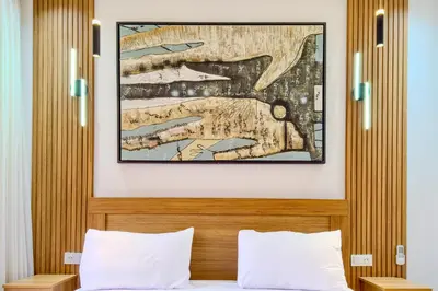 a painting above a bed in a hotel room at 17 - Top Location, NEUF, piscine & Comfort in Marrakech