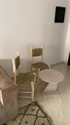 a living room with two chairs and a table at Familial Cosy Appart in Marrakech