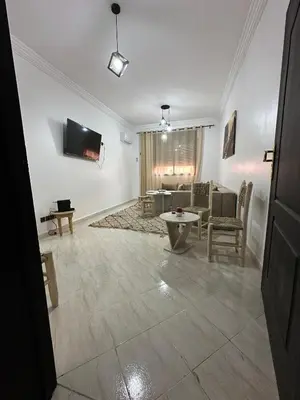a living room with a couch and a table at Familial Cosy Appart in Marrakech