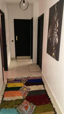 a hallway with a colorful rug on the floor at Familial Cosy Appart in Marrakech