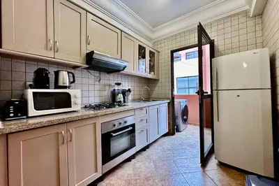 a kitchen with white appliances and a refrigerator at Apartment in Centre of Marrakech in Marrakech