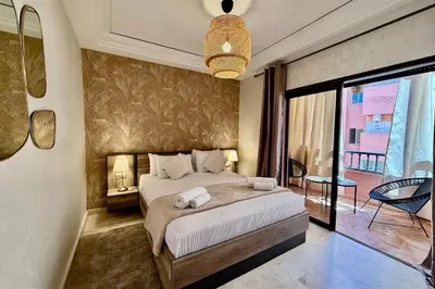 a bedroom with a large bed and a balcony at Apartment in Centre of Marrakech in Marrakech