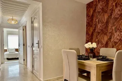 a dining room with a wooden table and chairs at Apartment in Centre of Marrakech in Marrakech