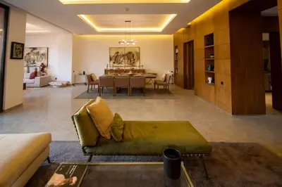a living room with a couch and a dining room at HM50 l Villa en front de golf piscine & jacuzzi in Marrakech