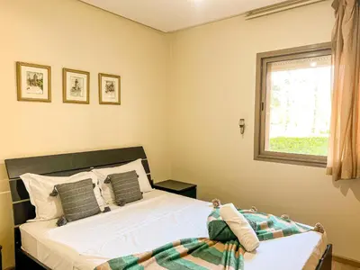 a bedroom with a bed and a window at Serene Stay Cozy Flat in Marrakech in Marrakech