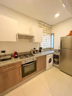 a kitchen with a stainless steel refrigerator and a dishwasher at Serene Stay Cozy Flat in Marrakech in Marrakech