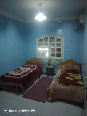 a bedroom with two beds and a window at Au cœur de Marrakech in Marrakech