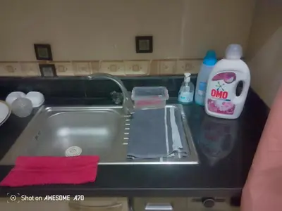 a kitchen counter with a sink and a bottle of soap at Au cœur de Marrakech in Marrakech