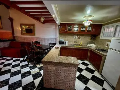 a kitchen with a black and white checkered floor at Riad Mido in Marrakech