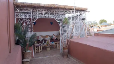 a gazebo with a table and chairs on a balcony at Riad kechin in Marrakech