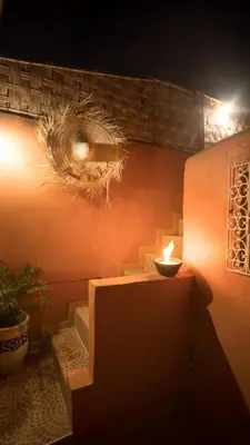 a room with stairs and a candle on the wall at Riad kechin in Marrakech