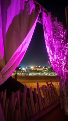 a room with purple lighting and a view of a beach at Riad kechin in Marrakech