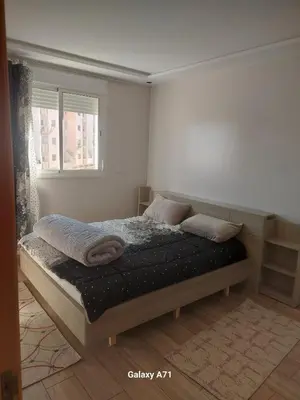 a bed in a white room with two pillows on it at Tout est Nouveau et Propre,au Centre marrakech in Marrakech