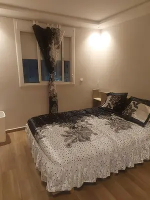 a bedroom with a bed with a curtain on it at Tout est Nouveau et Propre,au Centre marrakech in Marrakech