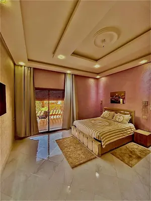 a bedroom with a large bed and a window at Villa à marrakech avec piscine in Marrakech