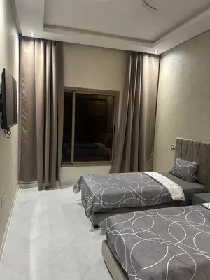 a hotel room with two beds and a window at Villa à marrakech avec piscine in Marrakech