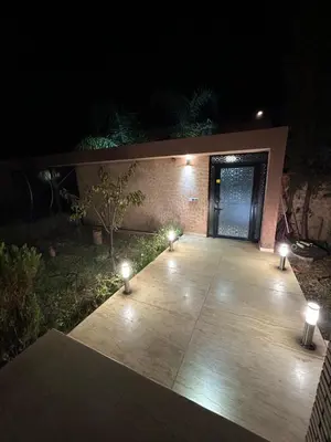 a patio at night with lights in front of a door at Villa à marrakech avec piscine in Marrakech