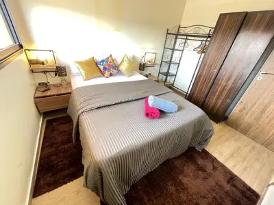 a bedroom with a pink stuffed animal sitting on a bed at Appartement bien équipé in Marrakech