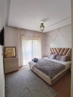 a bedroom with a large bed and a window at Marrakech Luxury ATLAS in Marrakech