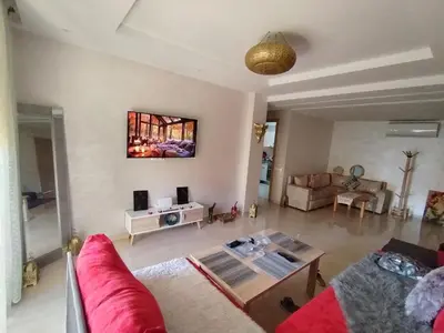 a living room with a red couch and a table at Marrakech Luxury ATLAS in Marrakech