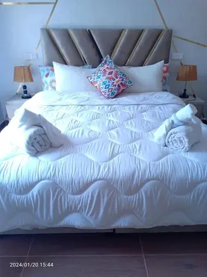 a large bed with white sheets and pillows at Marrakech Luxury ATLAS in Marrakech
