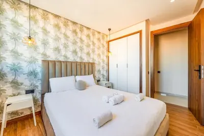 a bedroom with a bed with two towels on it at Luxe Urbain - 3 Chambres en Centre-Ville in Marrakech