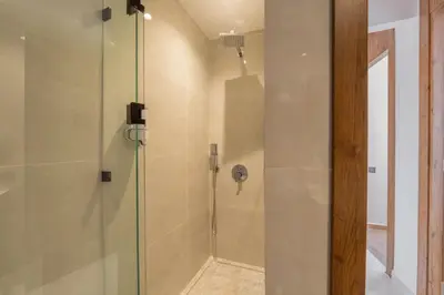 a shower with a glass door in a bathroom at Luxe Urbain - 3 Chambres en Centre-Ville in Marrakech