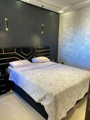 a bedroom with a large bed in a room at Au cœur de la Ville Rouge in Marrakech