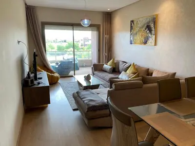 a living room with a couch and a table at Prestigia Aparts de Vacances by Sabor Voyage in Marrakech