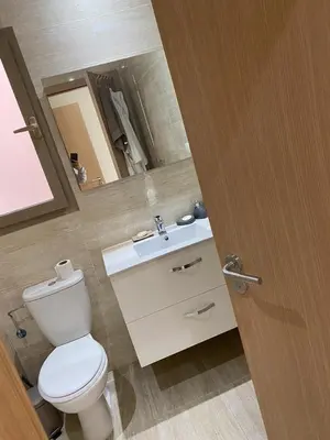a bathroom with a toilet and a sink with a mirror at Prestigia Aparts de Vacances by Sabor Voyage in Marrakech