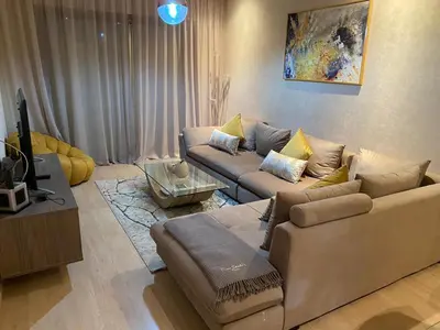 a living room with two couches and a tv at Prestigia Aparts de Vacances by Sabor Voyage in Marrakech