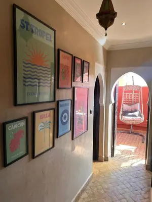 a hallway with a bunch of pictures on a wall at Un rêve à Marrakech in Marrakech