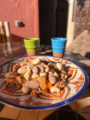 a plate of nuts and other food on a table at Un rêve à Marrakech in Marrakech