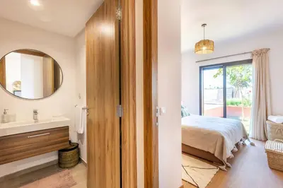 a bedroom with a bed and a sink and a mirror at Cute Place for Couple in Love - Pool in Marrakech