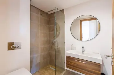 a bathroom with a shower and a sink and a mirror at Cute Place for Couple in Love - Pool in Marrakech