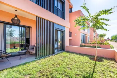 a house with sliding glass doors and a yard at Cute Place for Couple in Love - Pool in Marrakech