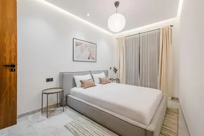 a bedroom with a large bed and a window at Stylish and Central Downtown Retreat in Marrakech