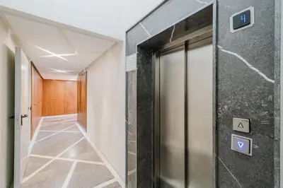 a elevator in a hallway with a tile floor at Stylish and Central Downtown Retreat in Marrakech