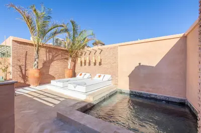 a backyard with a swimming pool and a couch on a patio at Dar KAJAM -Privatized Riad -10mn from Jamaa Al Fna in Marrakech